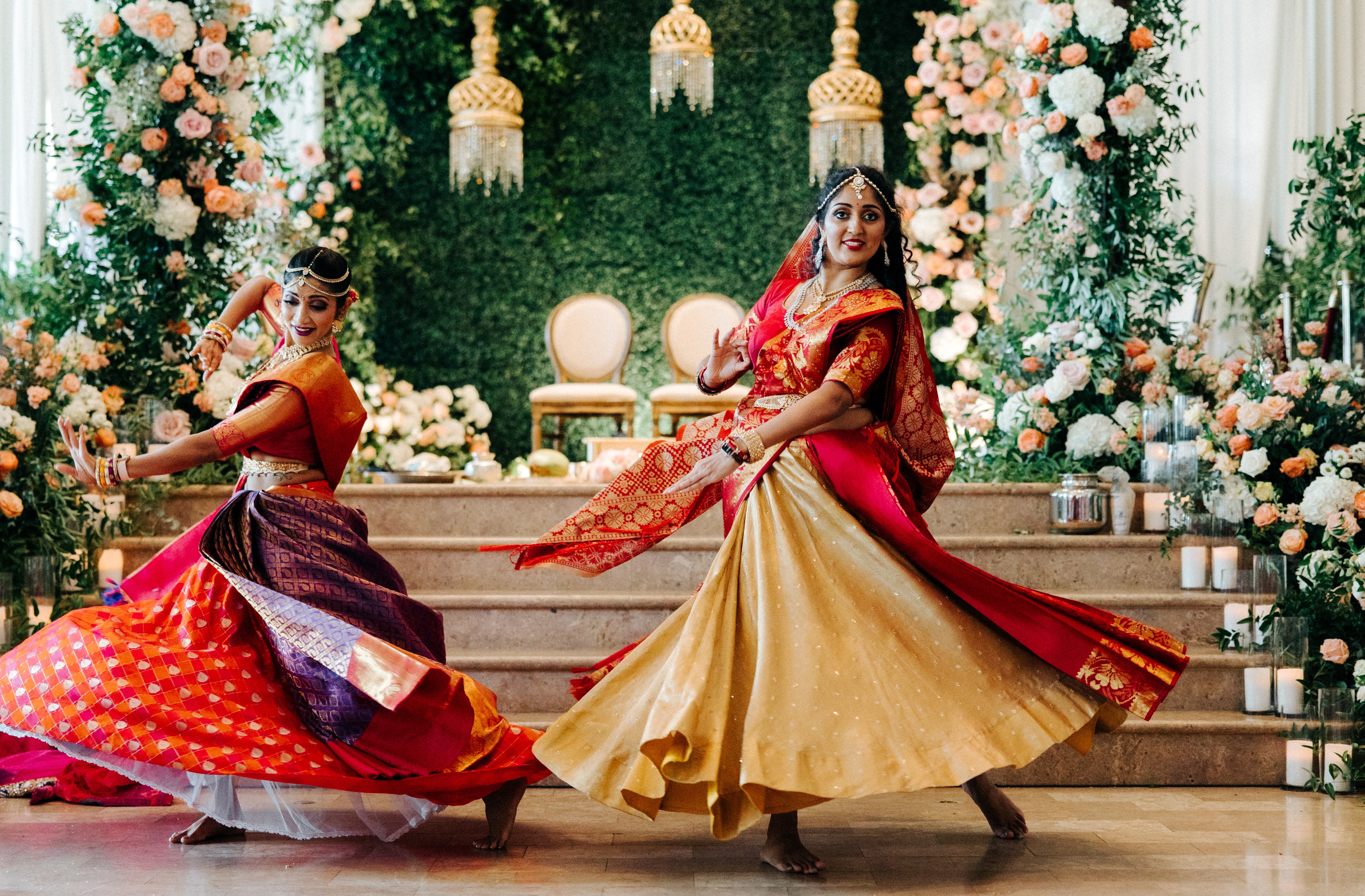 Wedding guests dance in traditional Indian wedding attire on the dancefloor at the wedding venue, The Corinthian.