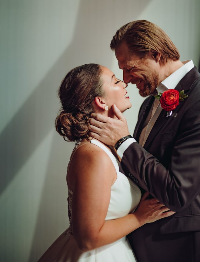 Bride and groom smile and embrace before their wedding ceremony in downtown Houston.