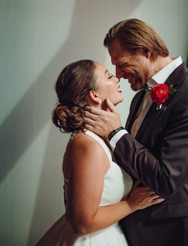 Bride and groom smile and embrace before their wedding ceremony in downtown Houston. 