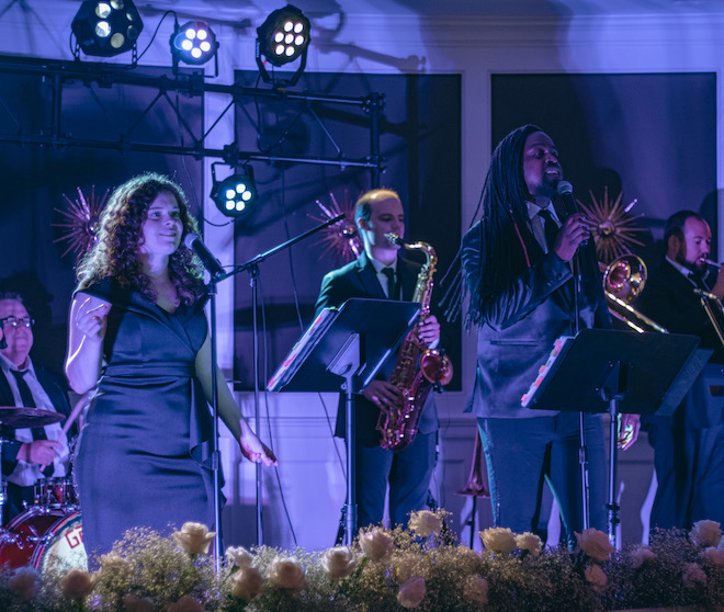 The live music and entertainment band, The Moment, performs at a wedding reception.