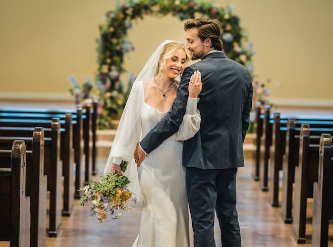 A bride and groom stand in the chapel at the wedding at the wedding venue, The Hundred Oaks. 