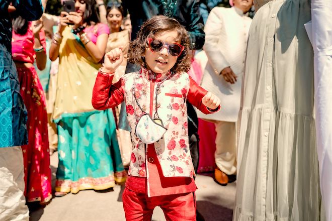 A child dancing during the Baraat before the ceremony