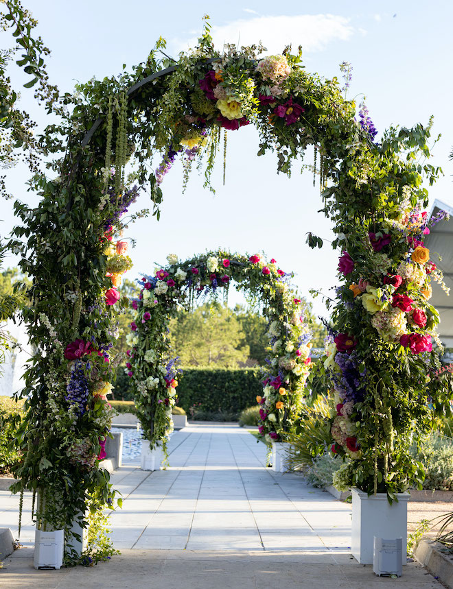 Vibrant floral arch designed and created by The Events Company in Houston, Texas. 