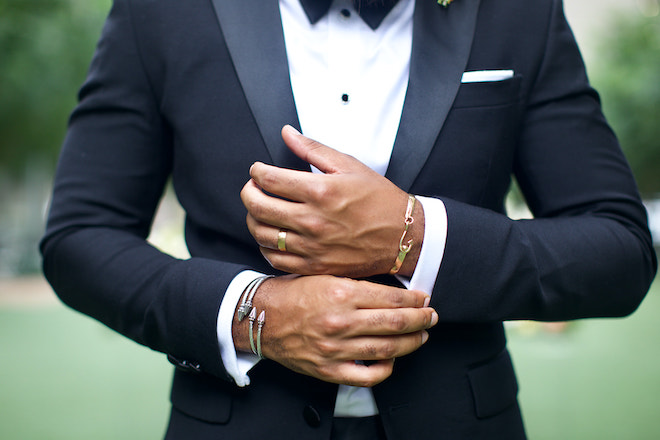 Close-up of the grooms bracelets and ring. 