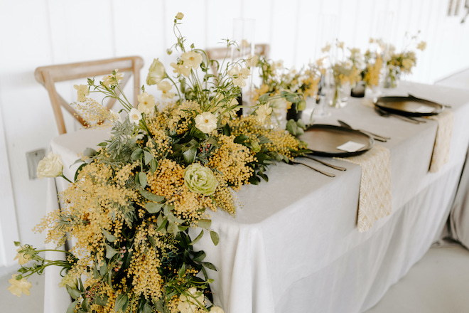 Yellow, white and green floral centerpiece created and designed by Pompom Florists. 
