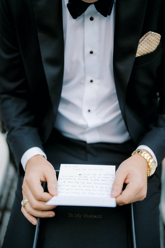 The groom reads a handwritten letter from his bride. 
