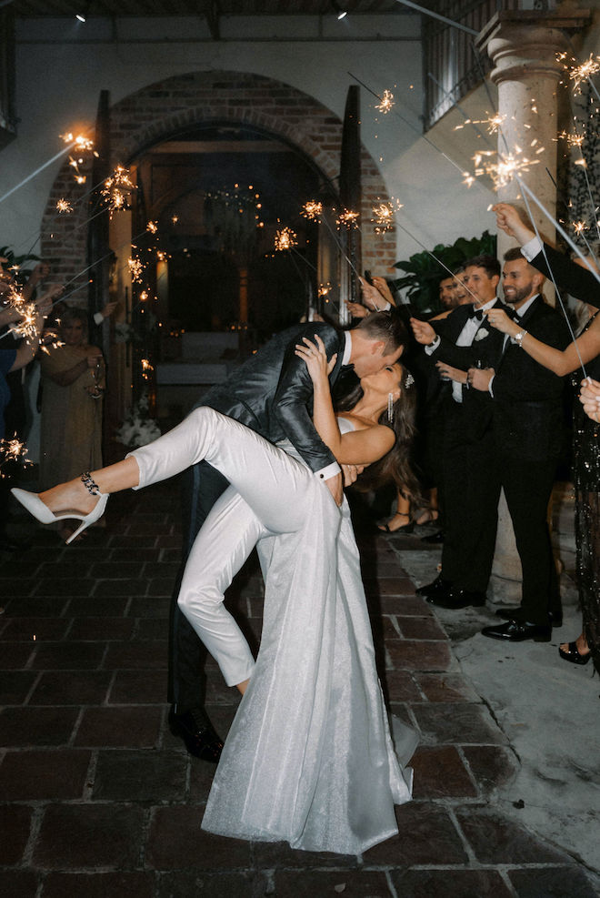 Bride and groom kiss during a sparkler send-off at their Houston wedding. 