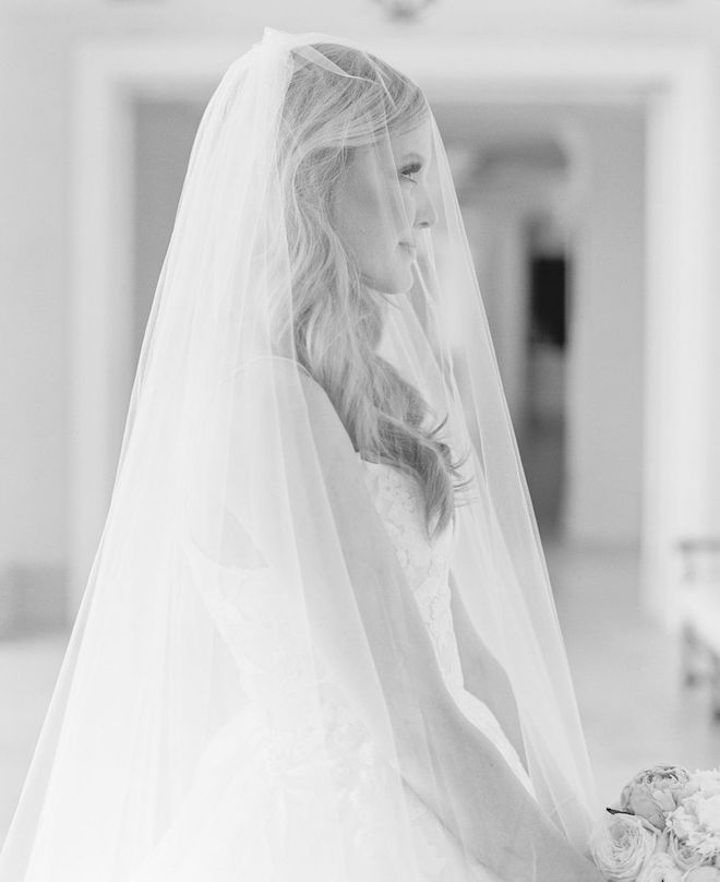 A bride wearing a veil at her church ceremony at Second Baptist Church in Houston, Texas.