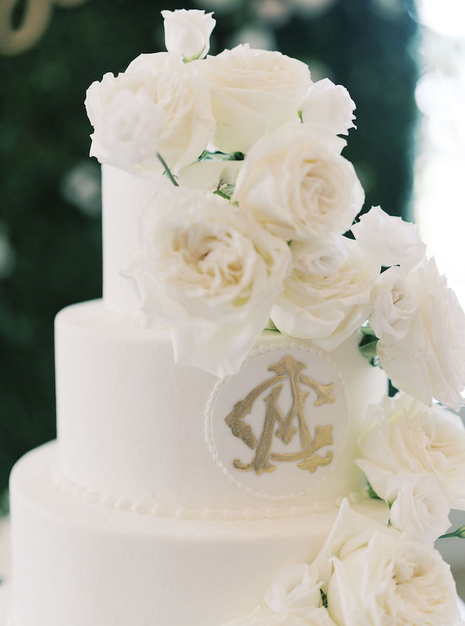 Ivory rose decorated wedding cake with gold detailing from Susie's cakes. 