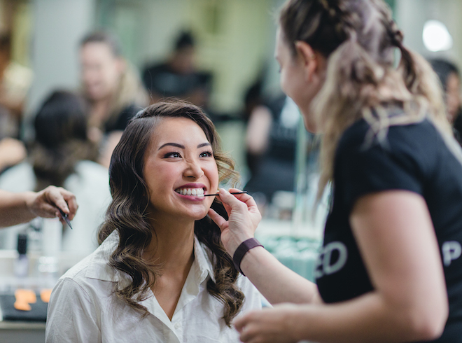 A Bride gets her makeup applied by Samantha from Polished Makeup and Hair at a vow renewal at Pine Forest Country Club 