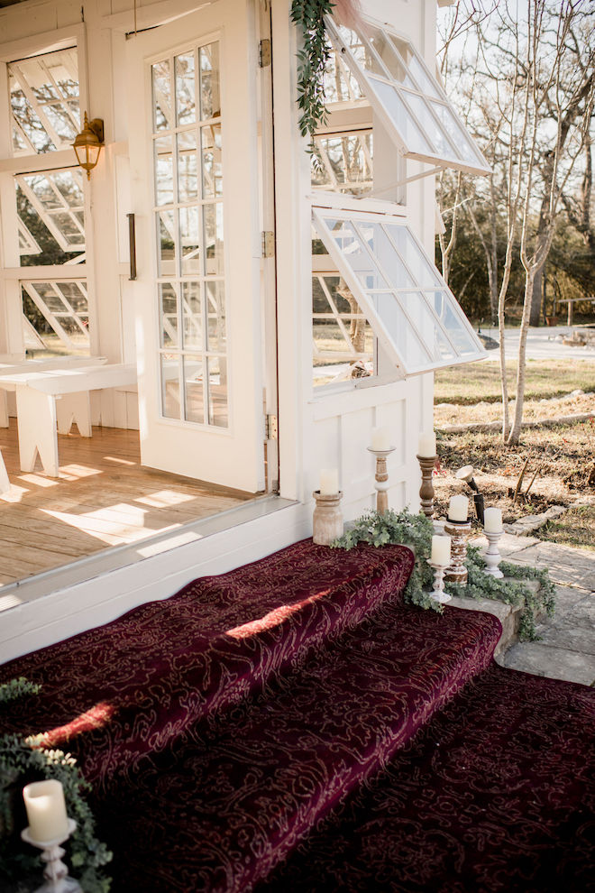 A red rug leading up to the sun-drenched chapel