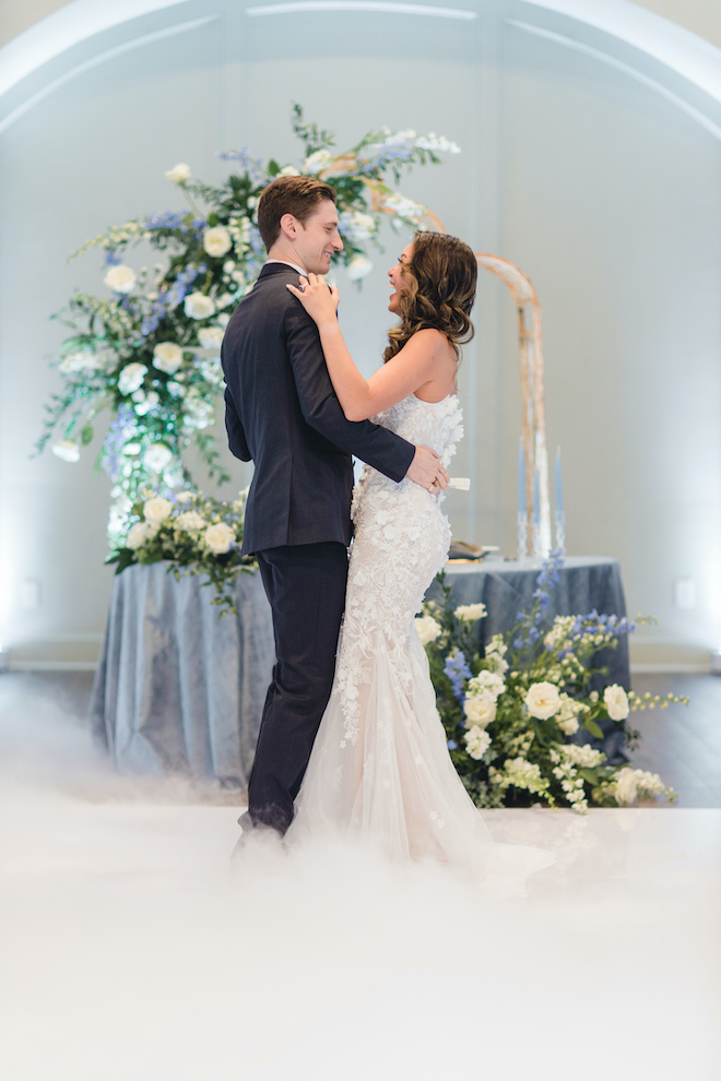 Bride and groom dance surrounded by white fog at their wedding reception and vow renewal in the Legacy Ballroom at Pine Forest Country Club.