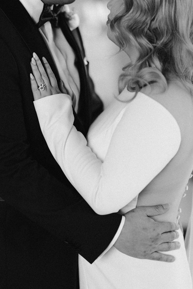 Bride resting her hand on the groom's chest at their wedding reception at The Astorian. 