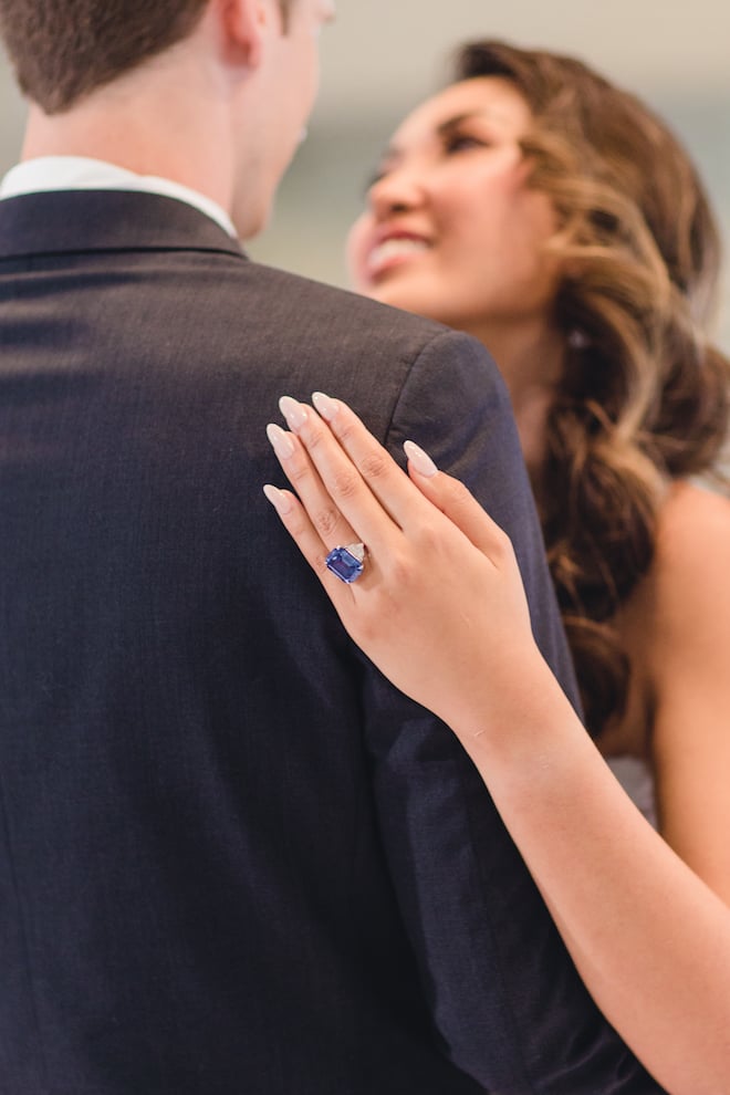 Bride wearing a blue sapphire wedding ring from Privosa dances with her husband at Pine Forest Country Club at their vow renewal