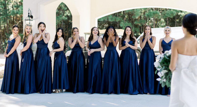 The bridesmaids reaction to seeing the bride in her strapless Rita Vinieris gown.