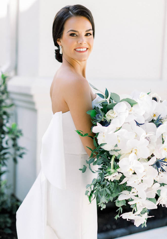 The bride smiling at her fall wedding full of navy and white hues at The Peach Orchard.
