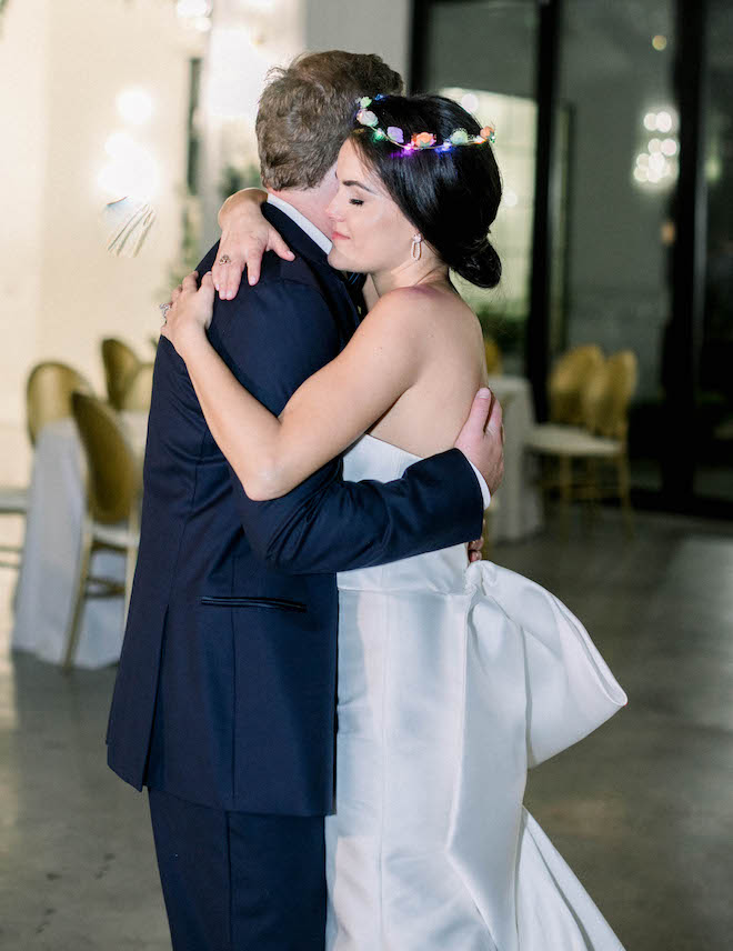 The couple hug as they slow dance during a private last dance.