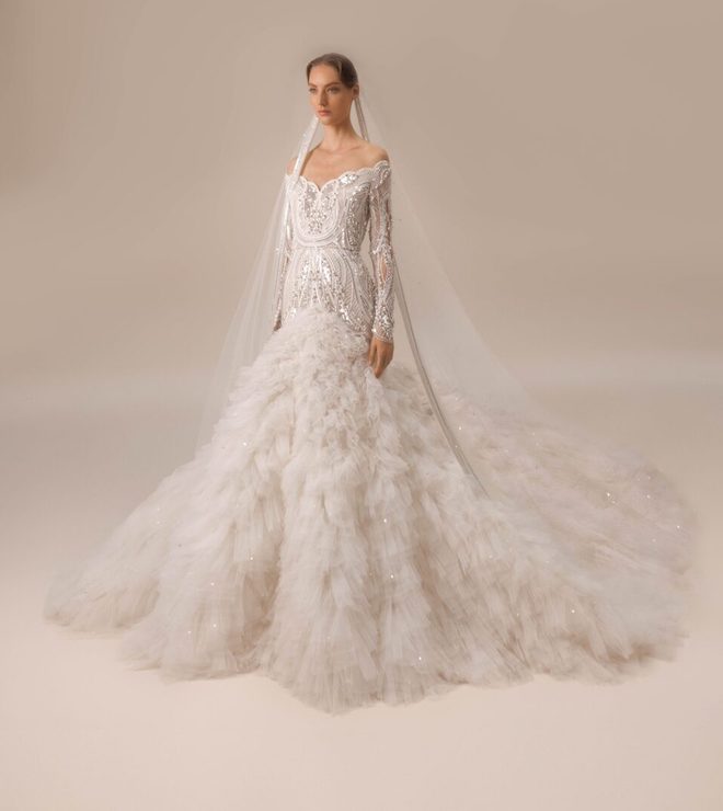 A beaded gown with long sleeves with a dramatic pleated ruffle at the bottom.
