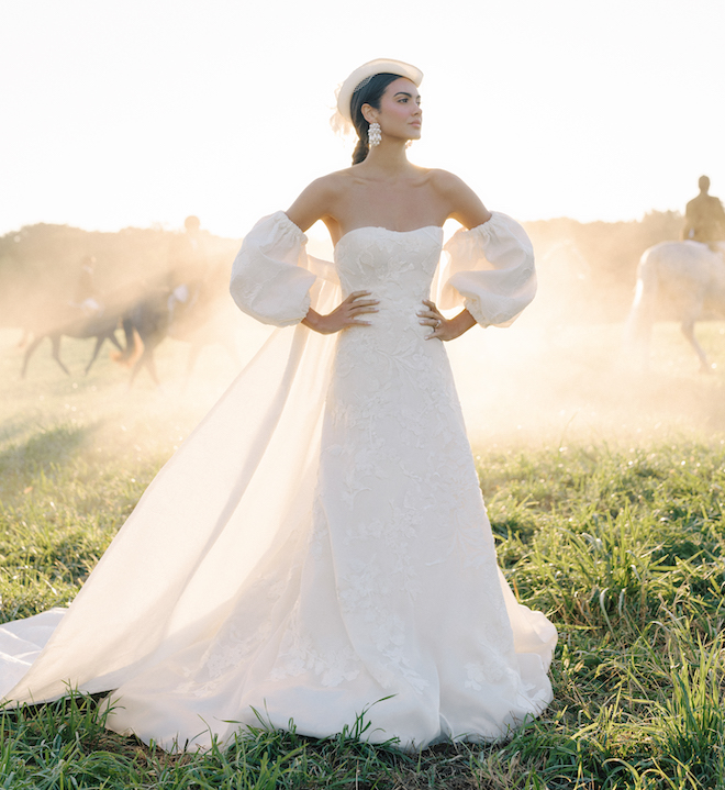 Model posing in nature while wearing the Georgina gown by Anne Barge.