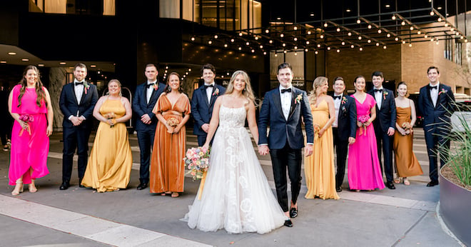 The bride and groom leading the wedding party out of the Four Seasons Hotel Houston.
