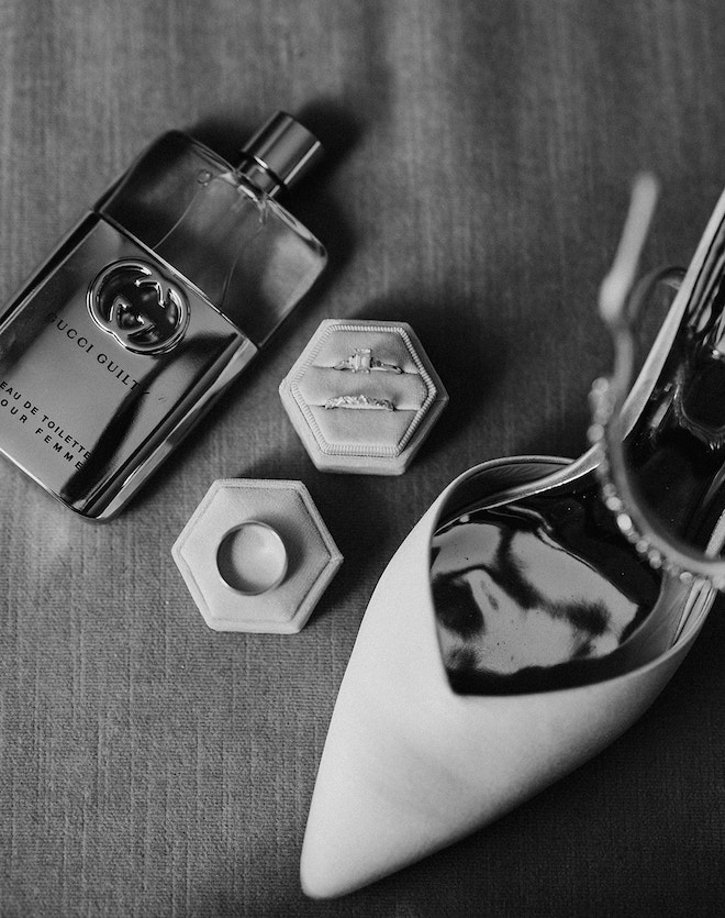 A bottle of "Gucci Guilty" perfume, wedding ring set and pointed velvet heels. 