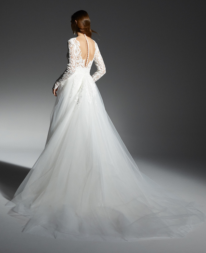 The back of the Kinsley gown by Rita Vinieris fall collection with lace sleeves.