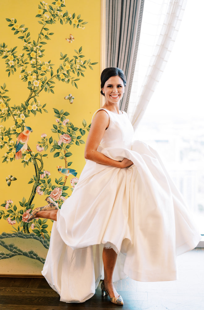 The bride posing with her Chinoiserie shoes that match her yellow chinoiserie panels.