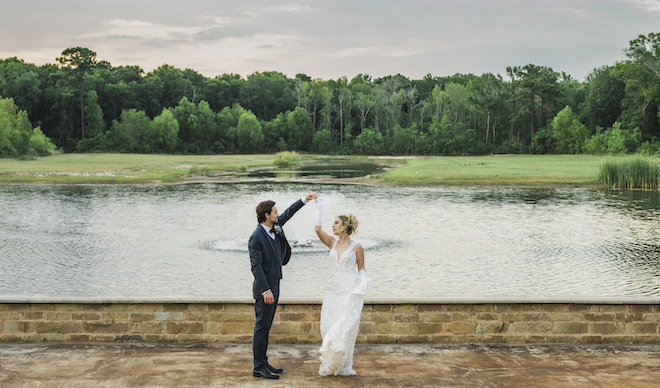 Bride and groom dancing in front of the pond at the Hundred Oaks Wedding & Event Center.