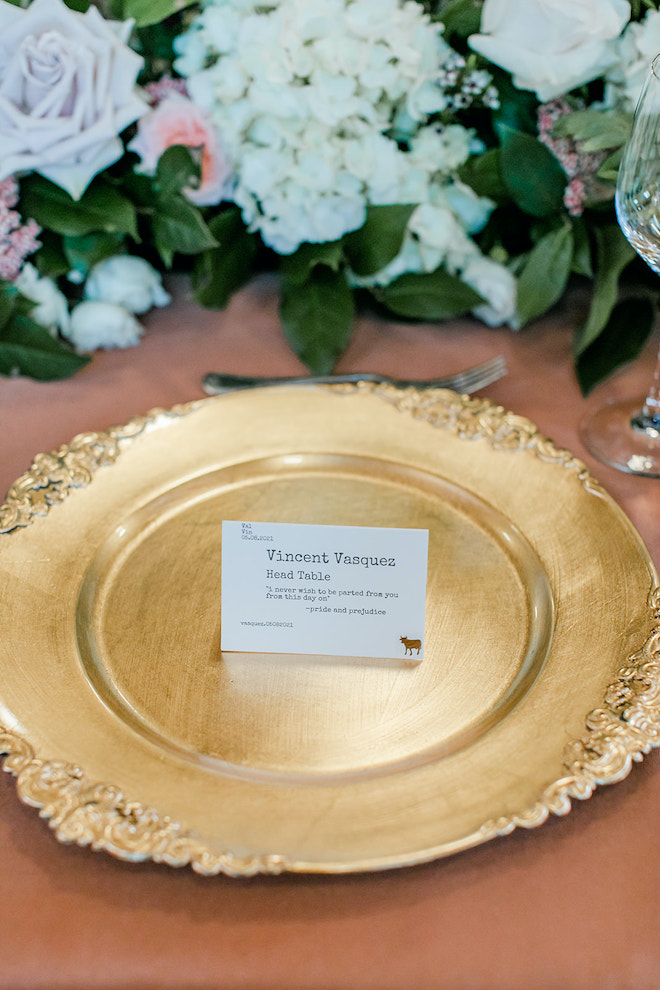 A gold plate with a card reading "Vincent Vasquez Head Table" with a quote.