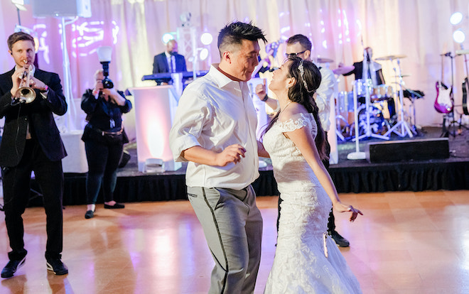 The bride and groom dancing while the band performs. 