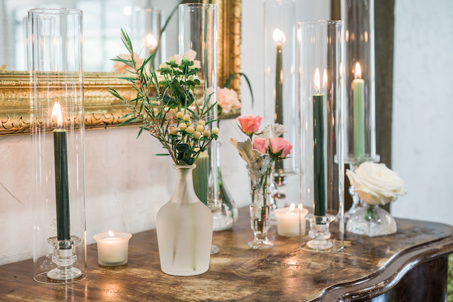 Candles and florals decorating the reception for the secret garden wedding editorial.
