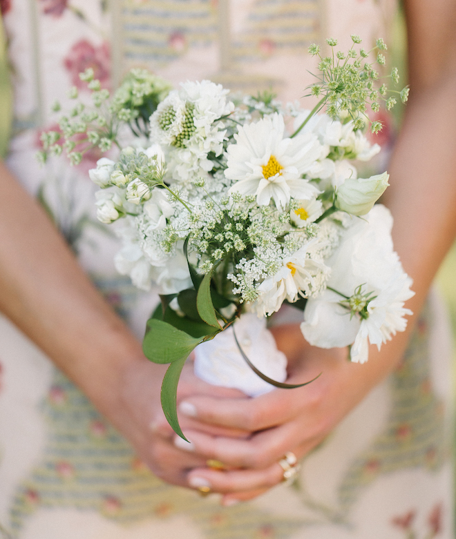 The bridesmaid bouquet with white flowers and greenery.