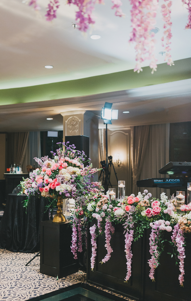 Pink and purple floral Installments at the glam wedding reception.