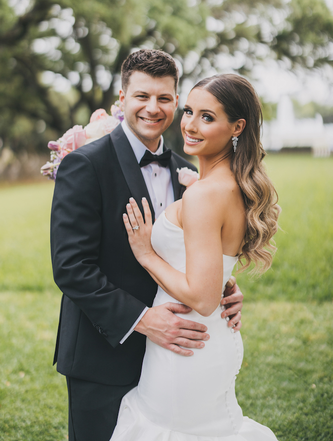 The bride and groom smiling before their glamorous wedding reception in the museum district.