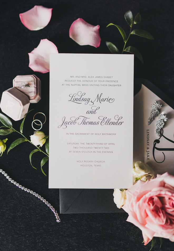 Invitation with flowers and the rings.