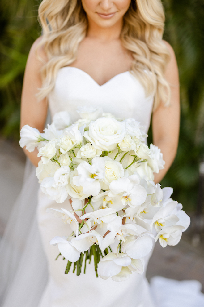 A white bridal bouquet with different blooms.