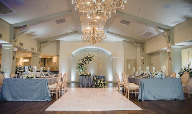 The ballroom in Pine Forest Country Club decorated with white and blue decor.
