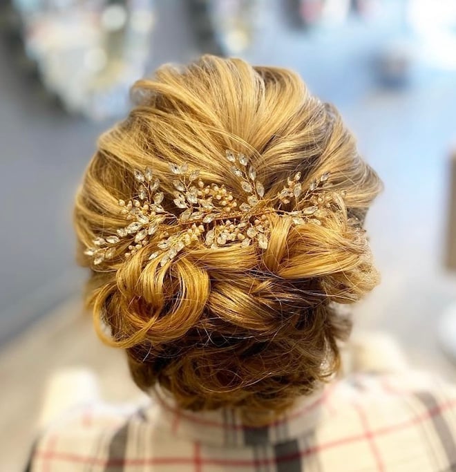 Blonde updo with a jeweled accessory.