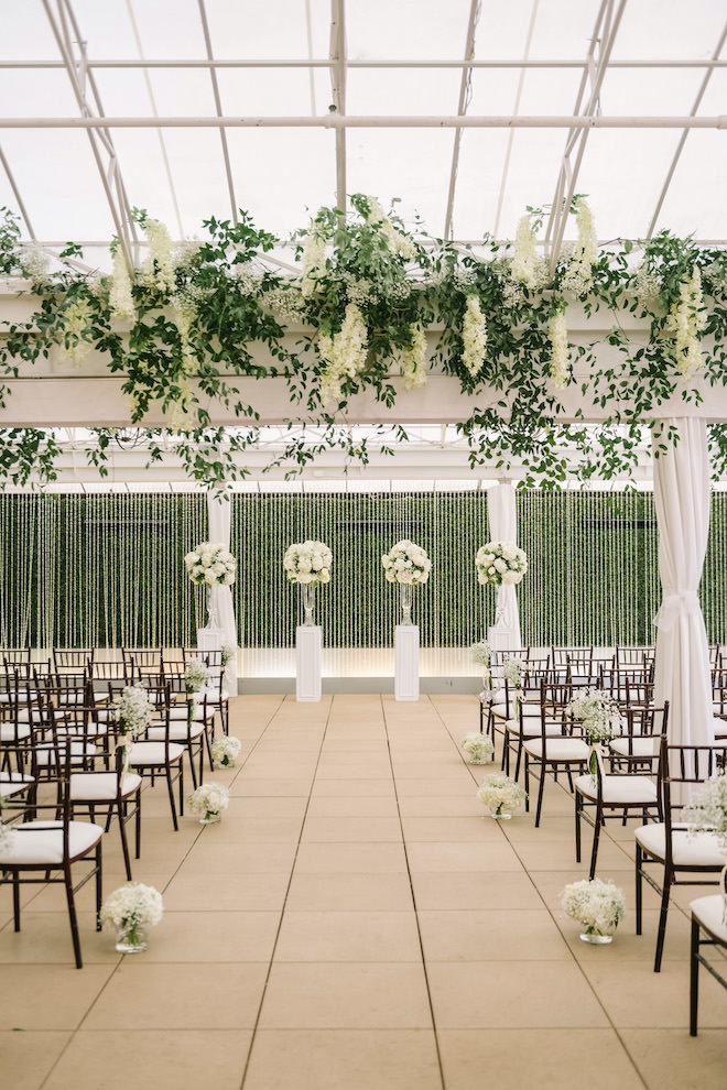 The Sam Houston Hotel ceremony space with white and forest green decor.