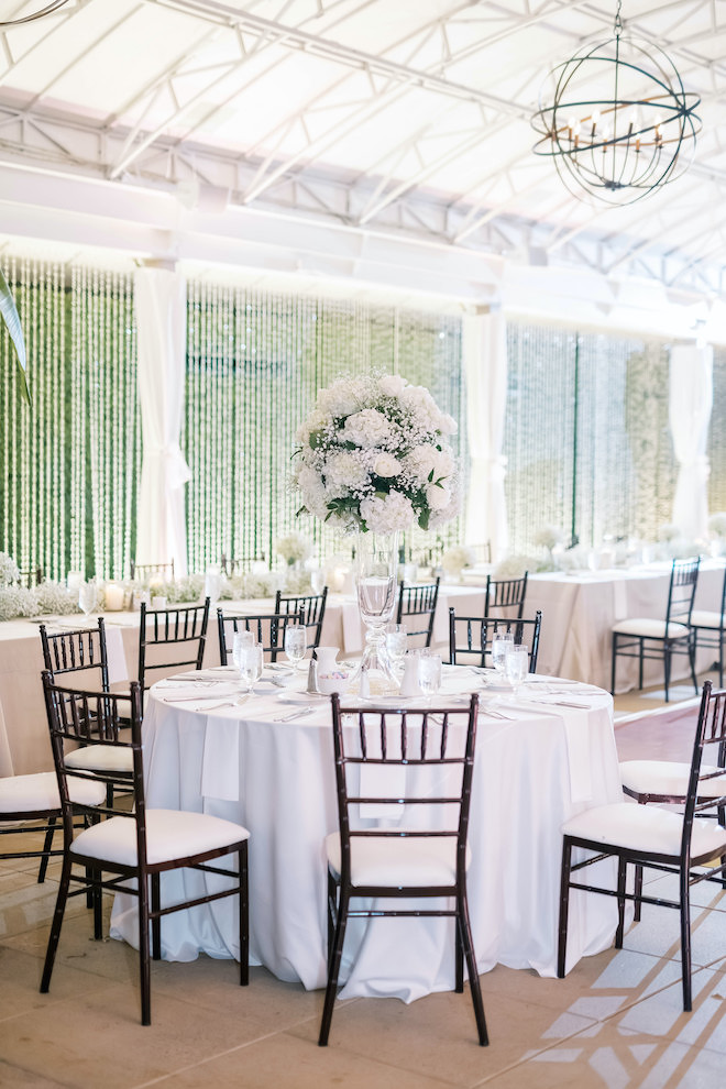 A reception table with white and forest green decor.