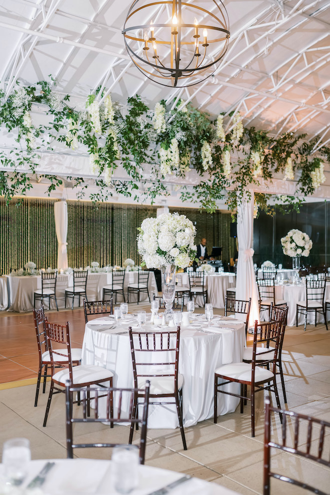 The reception space at the downtown boutique hotel covered in white and forest green decor.