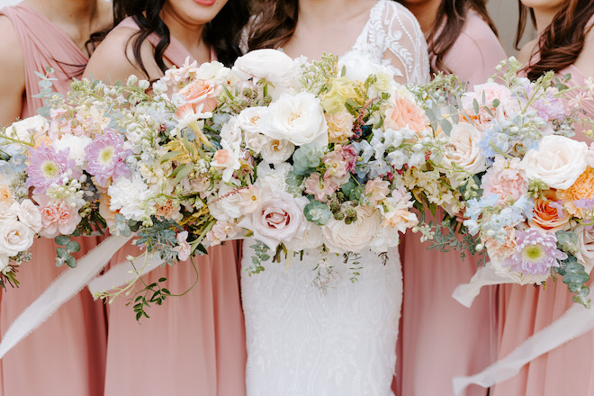 The pastel-hued bride and bridesmaid bouquets.