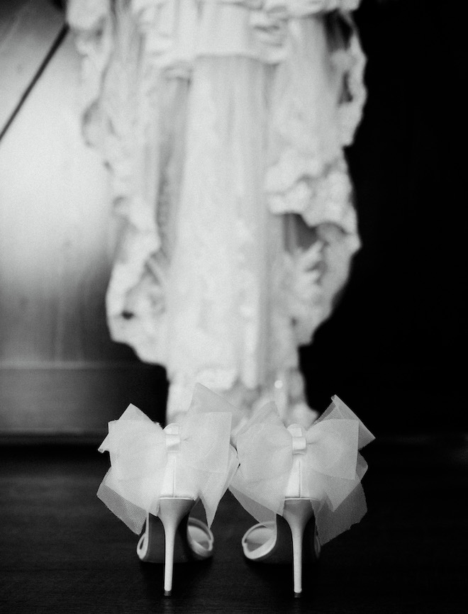 The brides white heels with bows on the back.