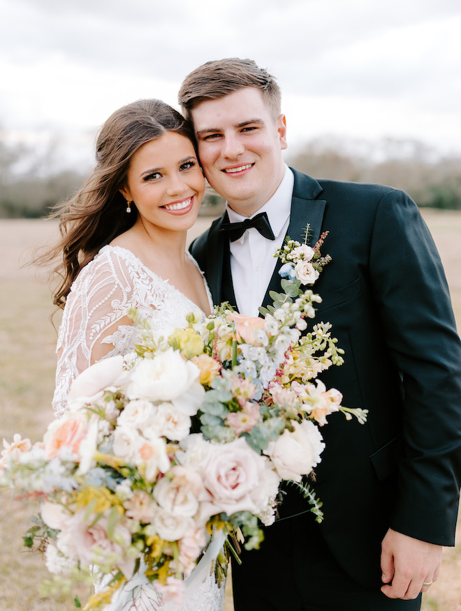 Bride holds a bouquet of florals aside a groom at brenham wedding venue, Deep in the Heart Farms