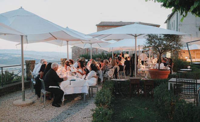 The reception with white umbrellas overlooking the Tuscan countryside.