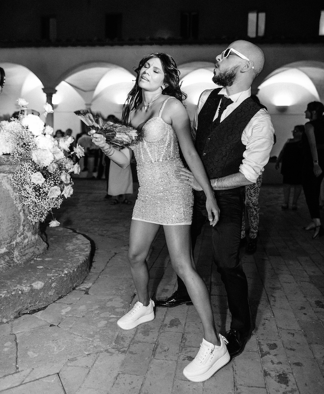 The bride in her mini dress dancing at their reception.