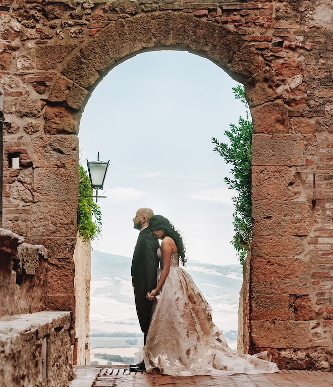 The bride hugging the groom from behind during their first touch.