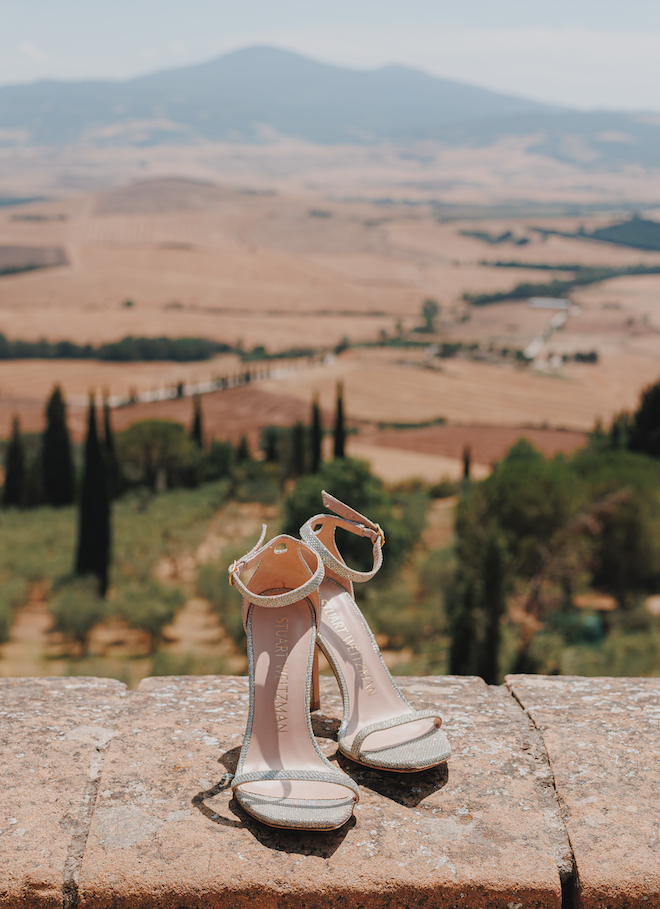 The brides heels with the Tuscan countryside in the background.