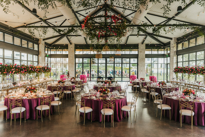 The hill country pavilion decorated with greenery and jewel toned linens.