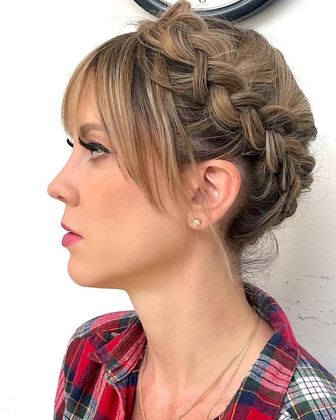 A woman with a thick braid for a short hairstyle.